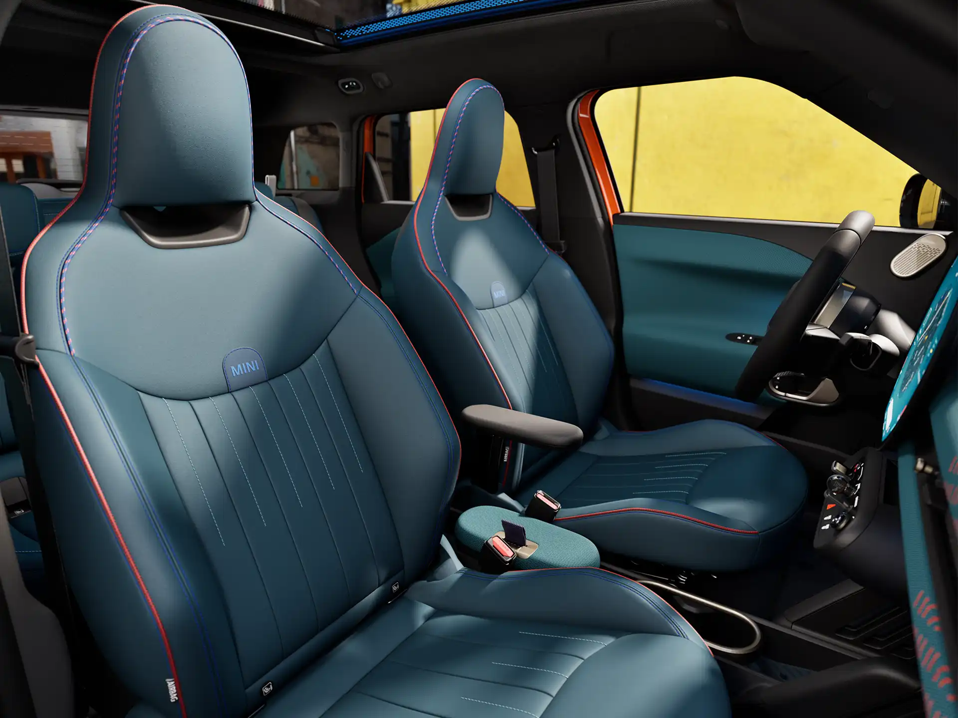 Interior perspective of the all-electric MINI Aceman is showing the dashboard, steering wheel, round display, panorama glassroof and back of the frontseats
