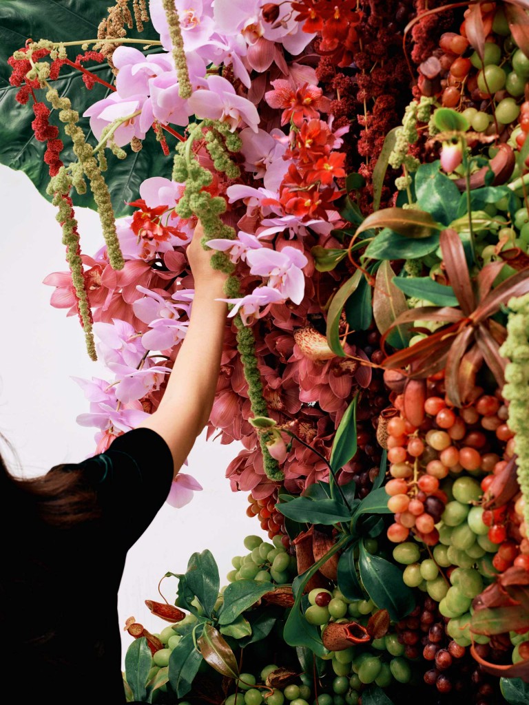 Detail shot of a scene at the set: Ruby is working on the floral artwork. 